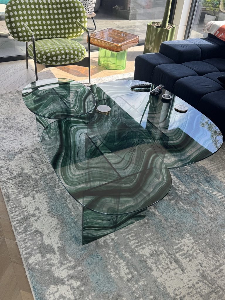 Green marbled glass coffee tables on a grey and blue rug